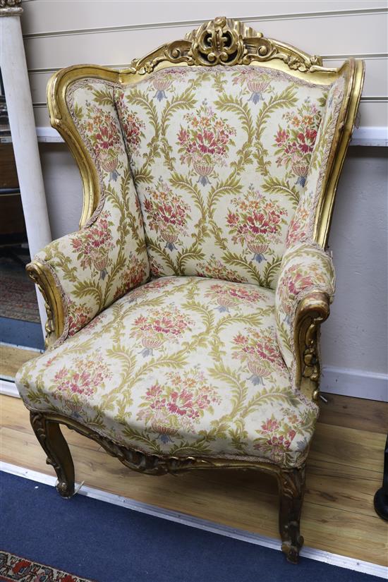 A pair of gilt armchairs